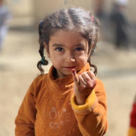 A child in Kandahar, Afghanistan shows her marked finger after being vaccinated against polio during the a vaccination campaign in September 2020 that targeted over 6 million children under five years of age. 