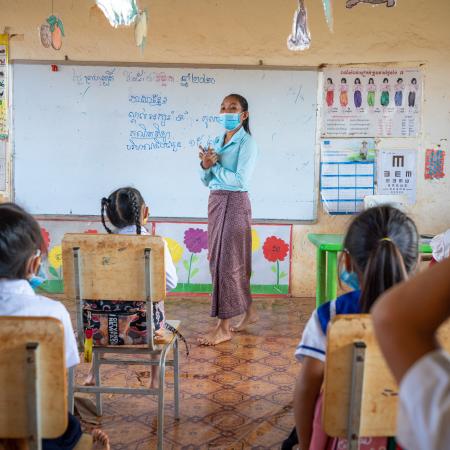 05 November 2020, Trom Village, Laminh Commune, Borkeo District, Rattanakiri, Cambodia. Portrait of MORN Sambo, 27, teacher at the village primary school of Trom, teaching a disabled student. 