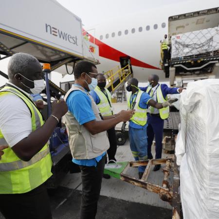 On 24 February 2021, staff unloads the first shipment of COVID-19 vaccines distributed by the COVAX Facility at the Kotoka International Airport in Accra, Ghana's capital.