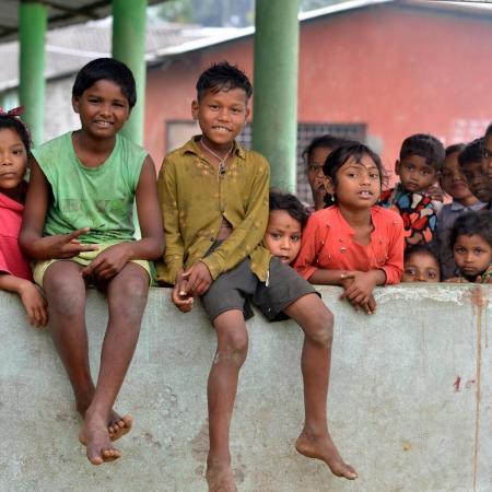 Children pose for a photograph at Mahabirbari Tea estate in Dibrughar district of Assam.