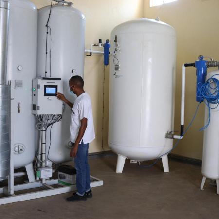 A technician checks an oxygen plant in Uganda.