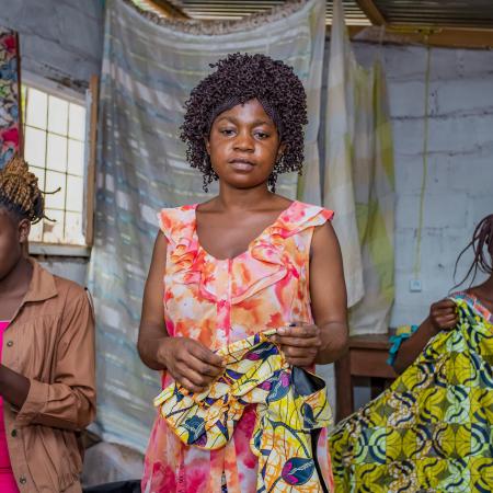 Students pose together at the sewing studio.