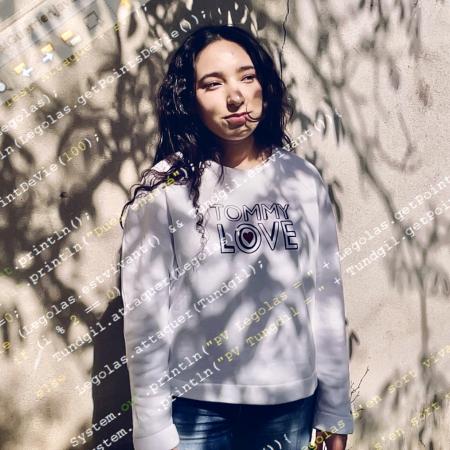 Houda, 19, poses for a portrait outside her family’s home near Grenoble, France.