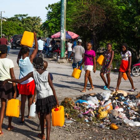 Young adults look for clean water in the city of Les Cayes, Haiti on 15 August 2021, following the 7.2 magnitude earthquake that struck on 14 August 2021.