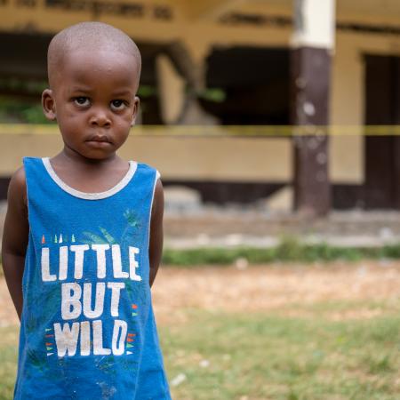 A young child stands in front of his school destroyed during the 2021 earthquake in Haiti.Notre Dame du Perpétuel Secours de Latibolière School destroyed following the earthquake that affected the South of Haiti on 14th August 2021.