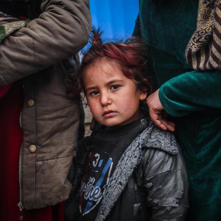 Children and families queue in front of a UNICEF mobile clinic in northeast Syria. 