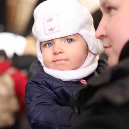 On 27 February 2022, as military operations continue in Ukraine, a woman carrying a small child waits to board an evacuation train at the railway station in Lviv, in Ukraine's westernmost corner, near the Polish border.