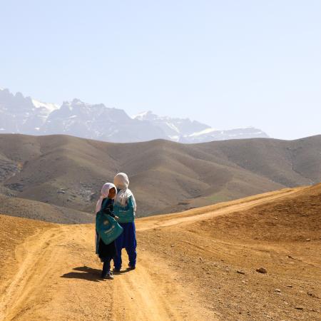 The students of Warkak's accelerated learning center in Daikundi Province walk home together over the dusty hills.