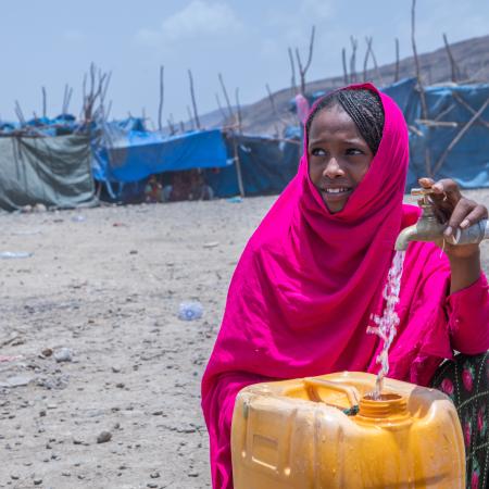 On 10 May 2022 in the internally displaced person (IDP) site of Guyah, Afar Region, Ethiopia, 13-year-old Keria fetches water from a UNICEF supported water point.