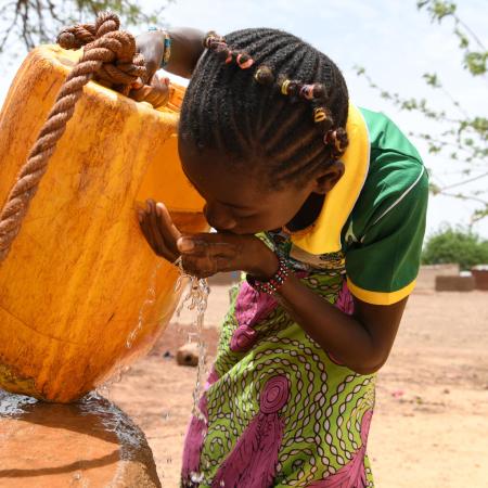 Children gathering water in the village of Naaba Guegma, in the Northern region of Burkina Faso.