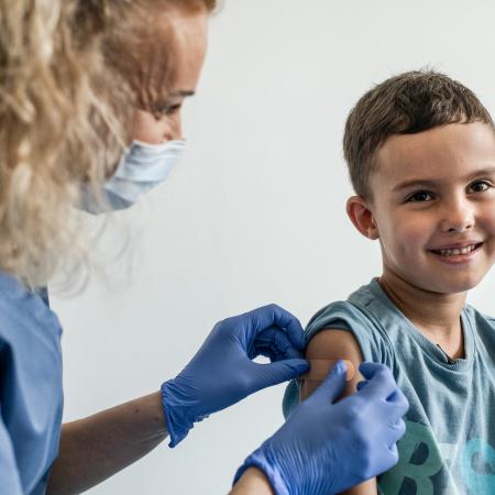 On 18 August 2022 in Kraków, Poland, 6-year-old Mykyta receives his immunizations from Nurse Ewelina Tytula at the UNIMED medical center.