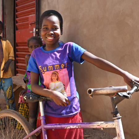 Awa Sobre, a 12 year old girl is very happy with her bicycle, in Dedougou, in the west of Burkina Faso.