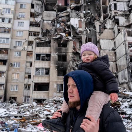 Oleksandr is on a walk in the courtyard with his two-year-old daughter Michelle in Saltivka, Ukraine.