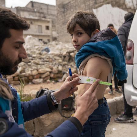 On 10 February 2023, Ayman, 5, is screened for malnutrition by a UNICEF-supported mobile health team worker.