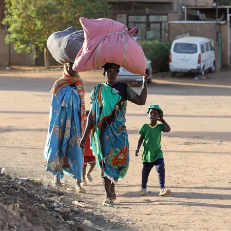 On 19 April 2023, people flee their neighbourhoods amid fighting between the army and paramilitaries in Khartoum, Sudan.