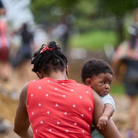 Esther, an Haitian mother of two children, arrives in pirogue to Lajas Blancas Migrant Temporary Reception Center, after crossing the Darien jungle with her husband. 