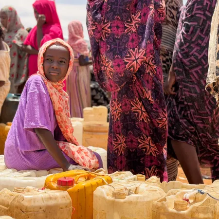 Children and women queue for water in Al Obeid, Sudan. 