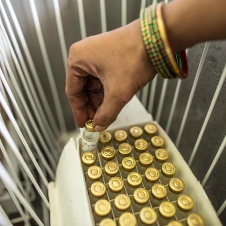 Pinky Kumari, Cold Chain Handler, prepares to keep vaccine in vaccine carriers at Primary health centre (PHE) in Begusarai, Bihar.