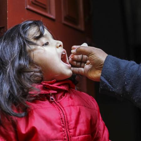 A little girl receives a polio vaccine.