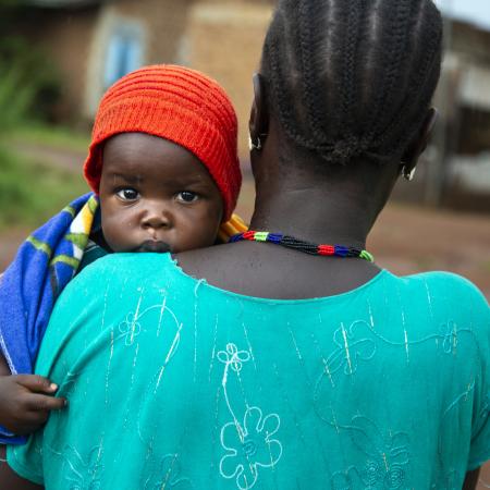 Veronica Marco Bareza carries her youngest child, Mubarak (9 months), at the hospital in Wau, South Sudan. 