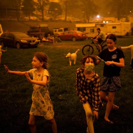 Children play at the showgrounds in the southern New South Wales town of Bega where they are camping after being evacuated from nearby sites affected by bushfires.