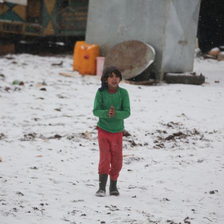 A child stands in a temporary camp for displaced persons in Syria.