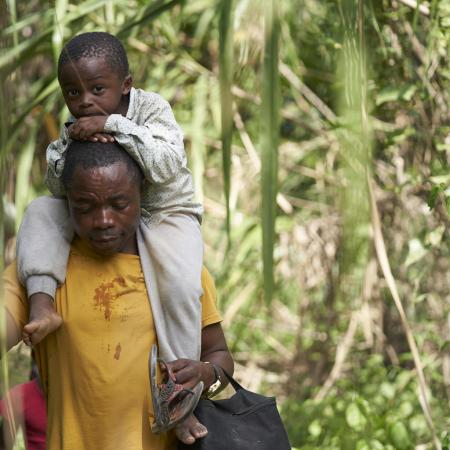 On 5 February 2020, Romeu Mauricio and his son, Jetfro, 3, cross through the Darien Gap jungle dividing Colombia and Panama.