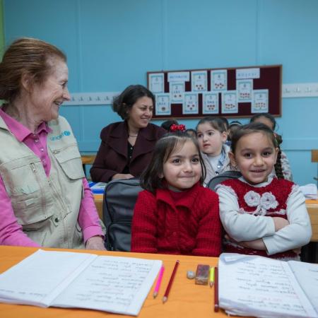 ED Fore sits with children in a classroom in Turkey.