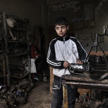 13 year old Ibrahim works in a mechanics shop to help support his family in Syria.