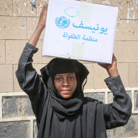 After being displaced by ongoing insecurity a young girl helps her family carry home a basic hygiene kit. They received urgent support through the Rapid Response Mechanism in Shuab