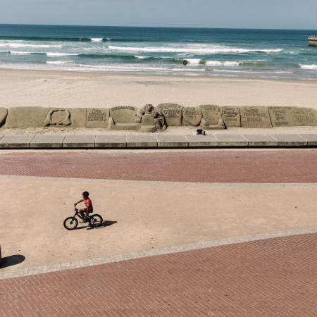 A lone cyclist rides along a beach in Durban.