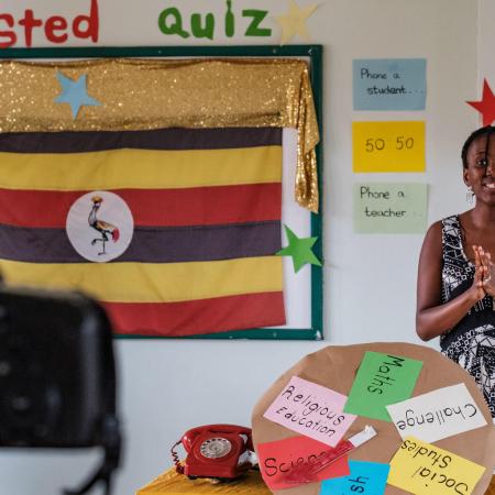 A teacher in Uganda records a lesson for a televised education broadcast.