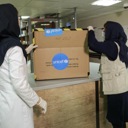Health workers inspect a delivery of supplies.
