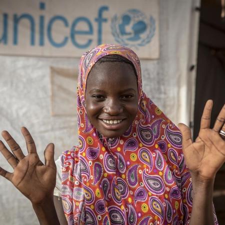 A youth advocate shows off her clean hands.