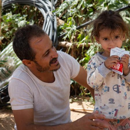 Moharram Al-Oshari, 35 years old, next to his 2 years and a half daughter, says "Before being displaced, I worked as a carpenter and we had a simple life"Mohammed Moharram Sa'ad Al-Oshari lives with his family in a camp for the displaced people in Ahl Al-Jalal in Mareb. Heis fled fighting with his family initially to Al Jawf and then, after Al Jawf was attacked, to Mareb. Although he receives a World Food Programme (WFP) food basket for his family, it is not enough.