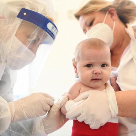 A baby receives a vaccination injection.