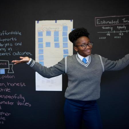 Sebabatso stands in front of her science class.