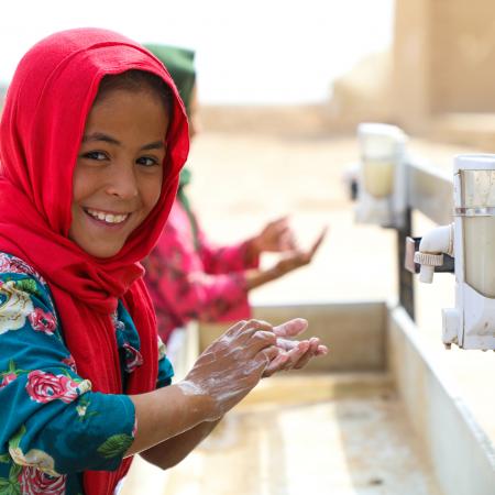Somaya, 9 is washing her hands at Balkh pronice of Afghanistan. UNICEF Afghanistan provide basic handwashing facilities for Internally displaced children at Ferdousi camp in Nahri Shahi district of Balkh province of Afghansitan.