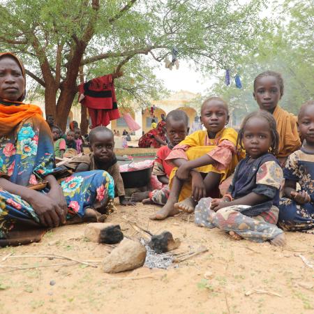 On 17 June 2023, Sudanese refugee Fatna Ibrahim Daoud, 35, a mother of 7, is sheltering in the shade in Adre, the Chadian city bordering Sudan. She fled the fighting with her 7-year-old daughter Isra. 