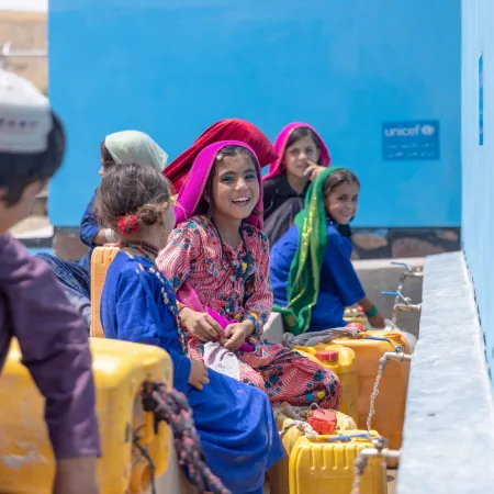Children collect water from a UNICEF-supported tap in Badghis Province, Afghanistan.