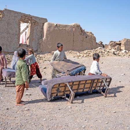 On 14th October 2023, children collect furniture from their destroyed homes following the recent earthquakes in Zinda Jan District, western Afghanistan.