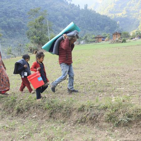 On 6 November 2023, in Aathbiskot Municipality in Rukum West District – in one of the communities most affected by the 6.4 magnitude quake that hit western Nepal on 3 November – a family of four receive relief supplies distributed by UNICEF in coordination with local authorities.