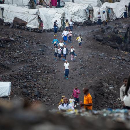 Displaced children on their way to school at the Lushagala IDP site in North Kivu province, DR Congo on 11 September 2023. UNICEF and its partners have set up temporary learning spaces in the site to allow displaced children to continue their learning.