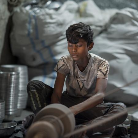 A child works in small silver polishing factory in Bangladesh