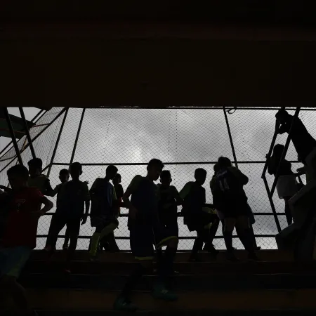 Silhouette of children standing on a balcony