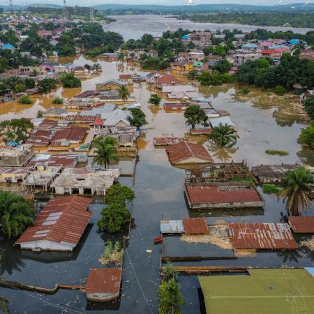 The image captures a Bird's eye-view of houses being flooded.