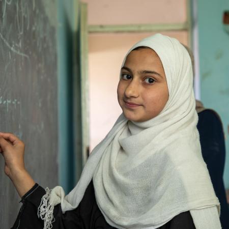 On 11 June 2024, primary school students in Kabul interact with other students and teachers.