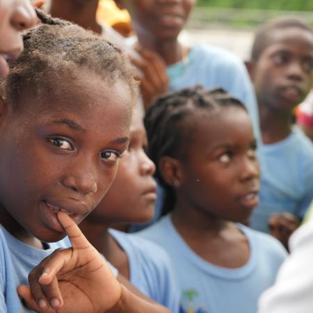 A child in Haiti looks towards the camera. 