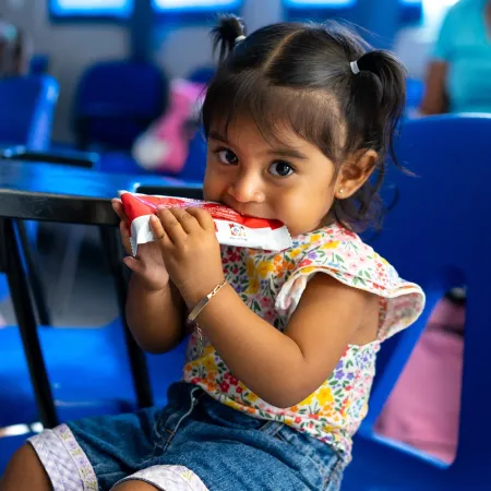 A girl eating Plumpy'Nut