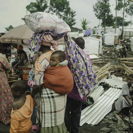 Families who had been living in displaced persons camps around Goma seek shelter on their way to Shasha village in North Kivu province, DR Congo